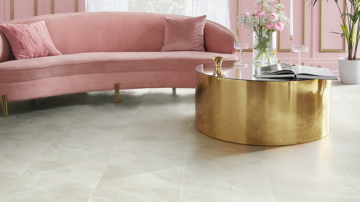 Karndean Commercial vinyl flooring Art Select Pearl Onyx stone tiles in a living space with pink sofa