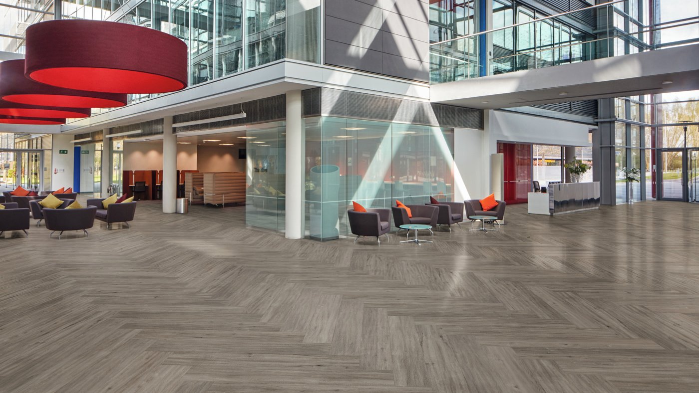 Herringbone French Grey Oak LLP308 floors in the main lobby of a large office building