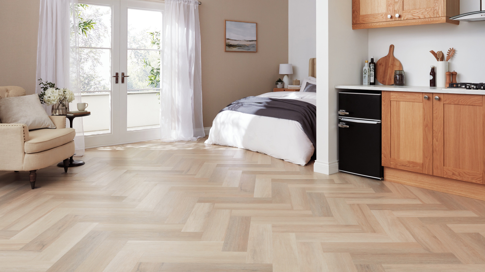 Karndean Commercial Texas White Ash herringbone LVT wood flooring in a hotel room