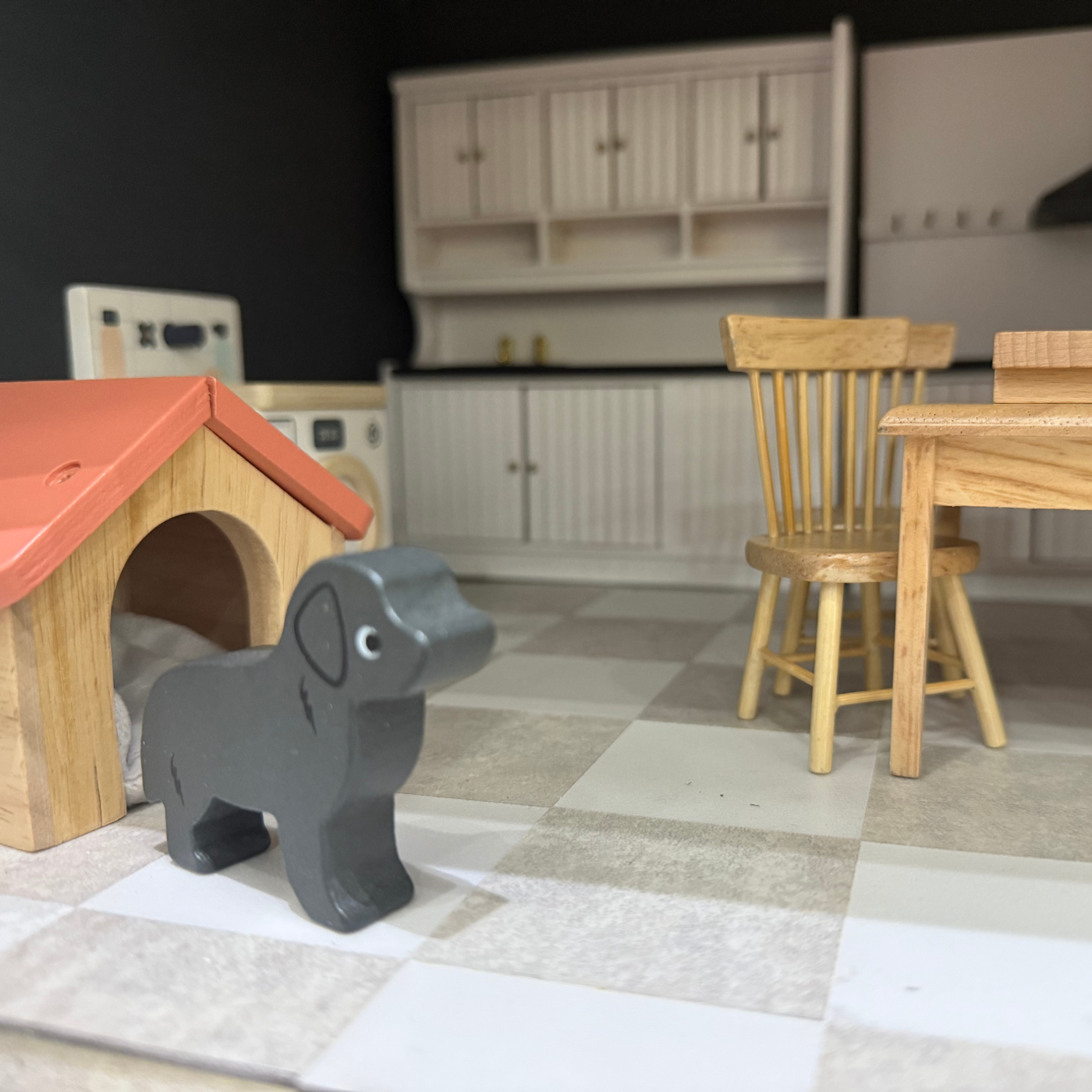 Dolls house kitchen with a dog