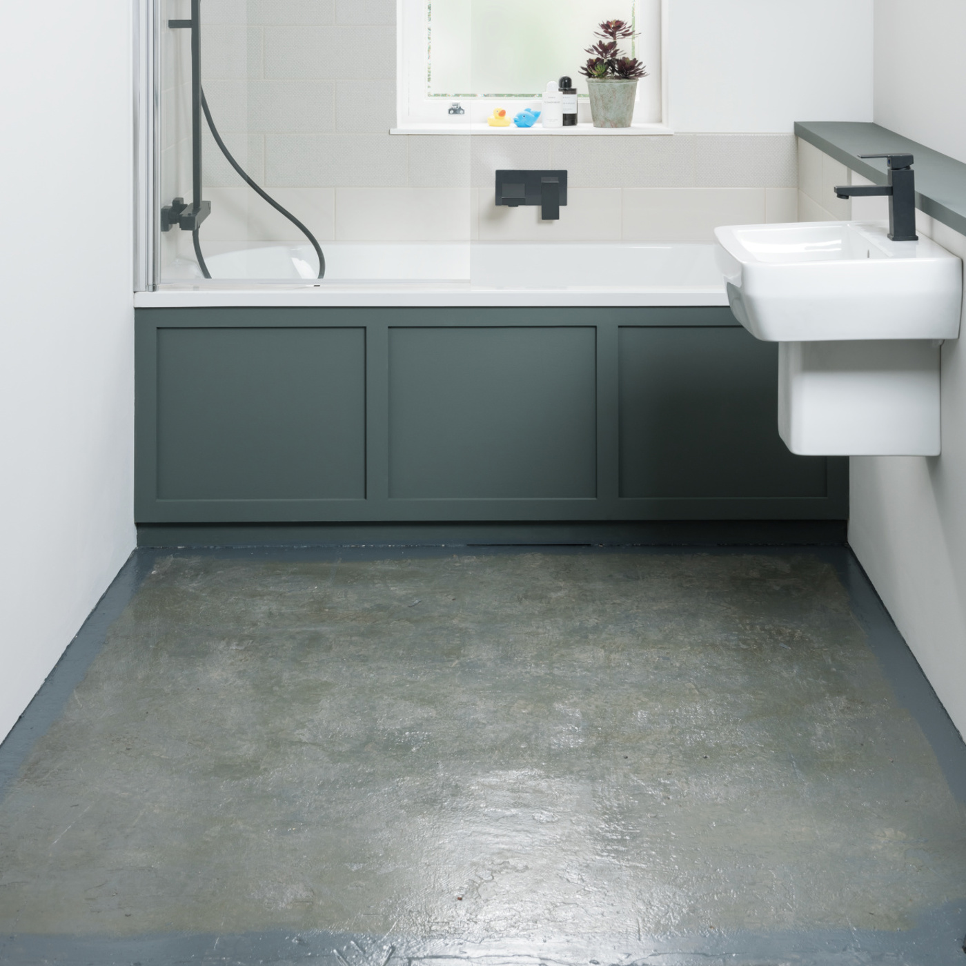 Bathroom with concrete subfloor exposed