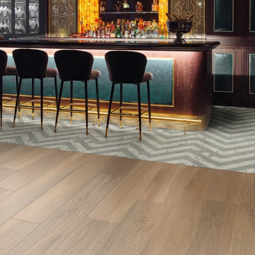 Bar area zoned with custom cut Calacatta d'Oro LM33 and Pavimento Bianco LM42 herringbone floors with Dune Oak RL24 floors outside